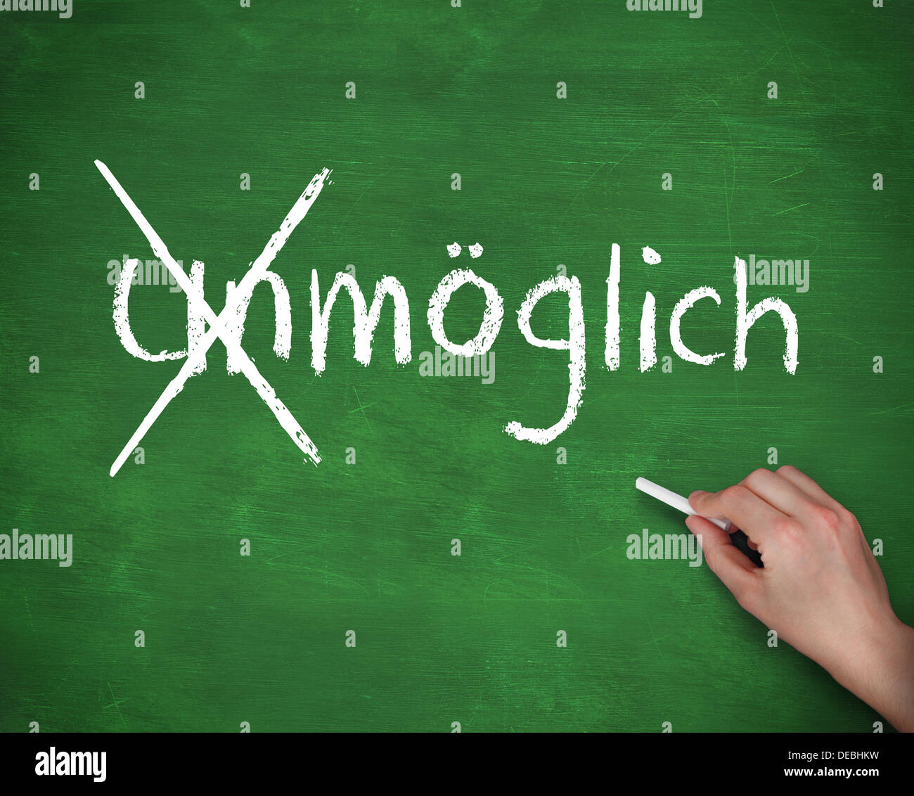 Hand crossing out the german word unmoglich Stock Photo