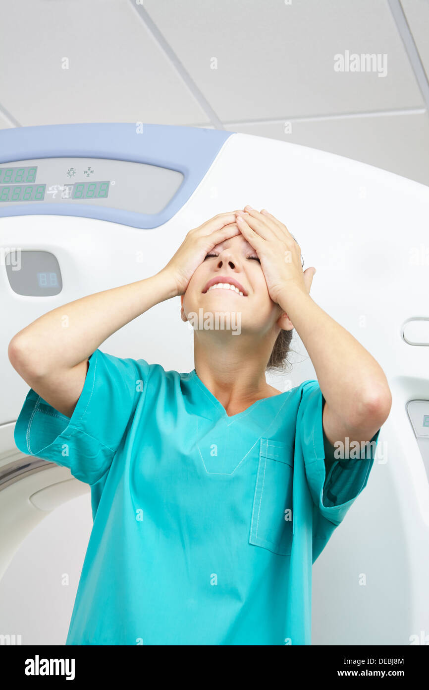 Young MTA slapping happily her face with her hand in a hospital Stock Photo