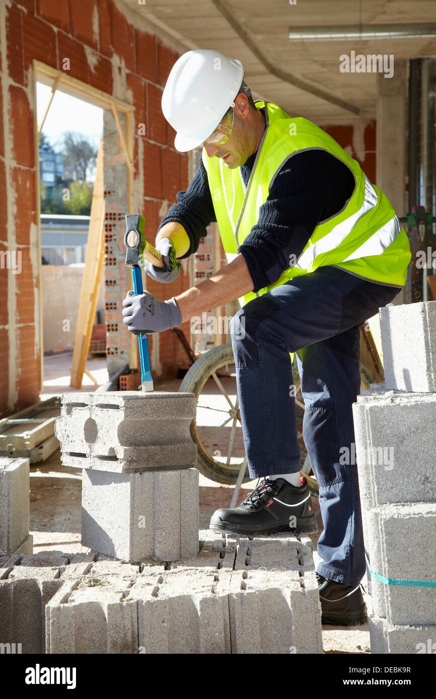 Construction worker with sledgehammer and chisel, Building hand tool