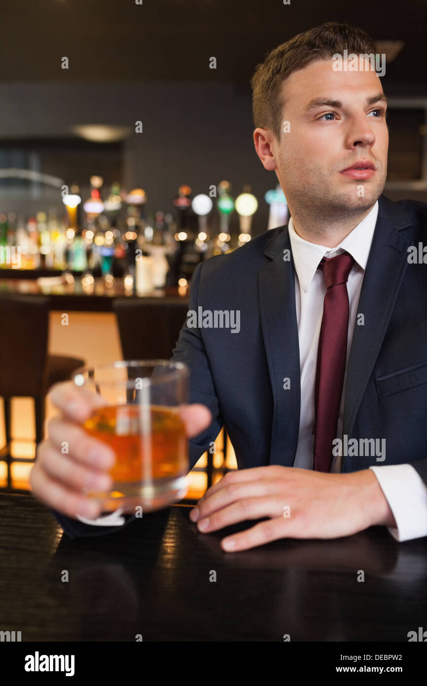 Thoughtful businessman having a drink Stock Photo