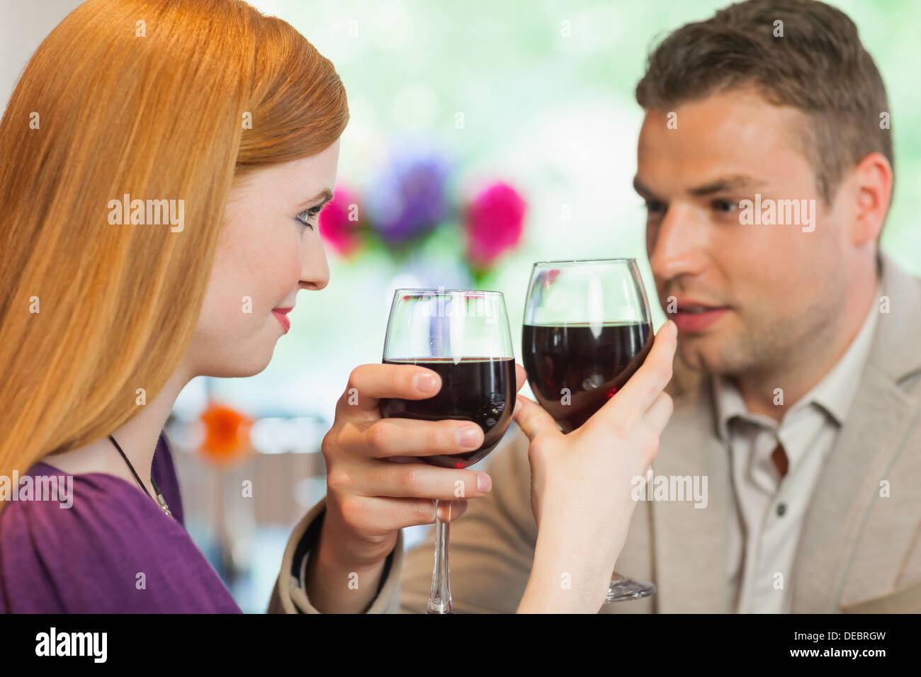 Handsome man having glass of wine with his pretty girlfriend Stock Photo