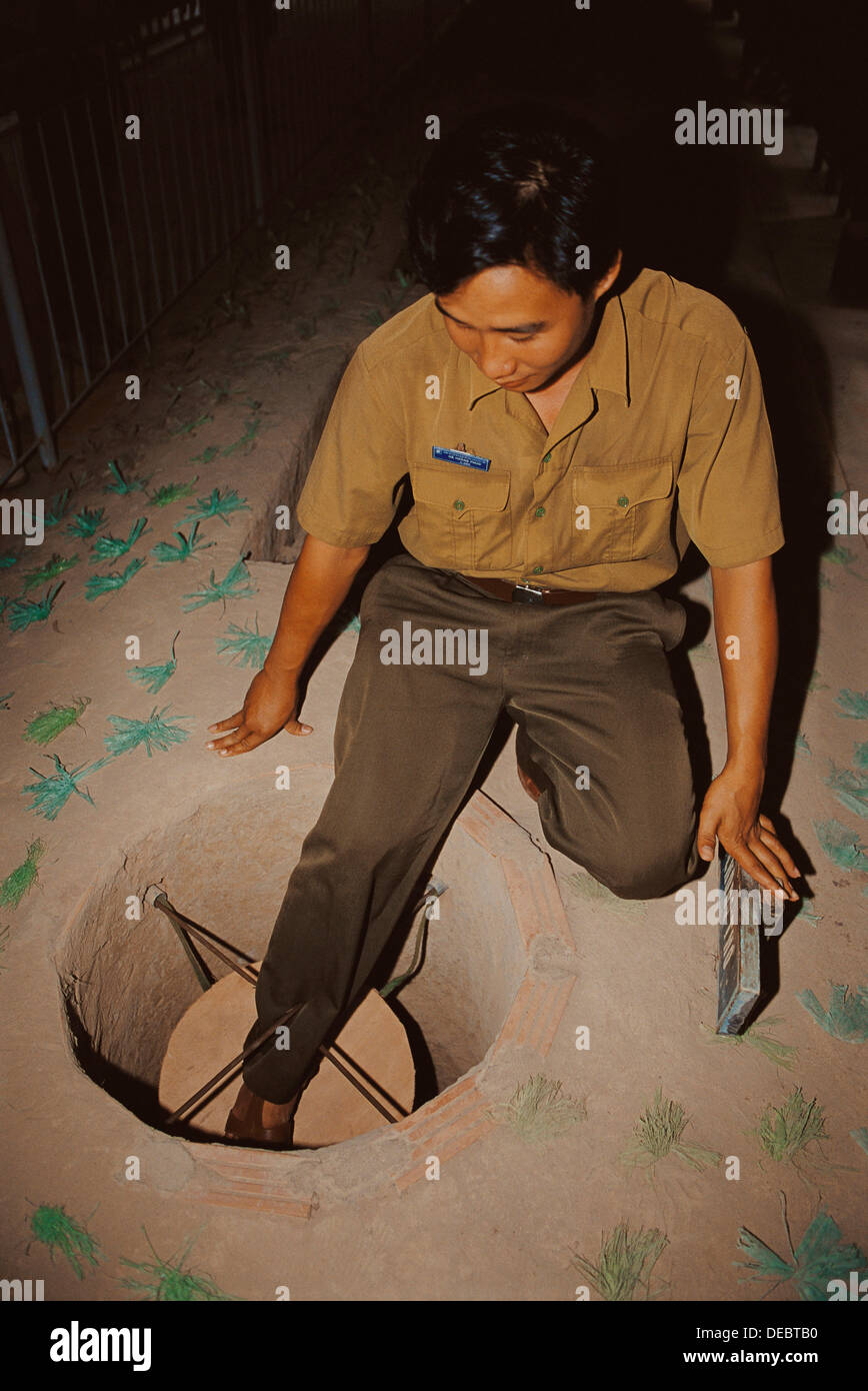 Soldier showing a trap in the Cu Chi tunnels, used by the Viet Cong