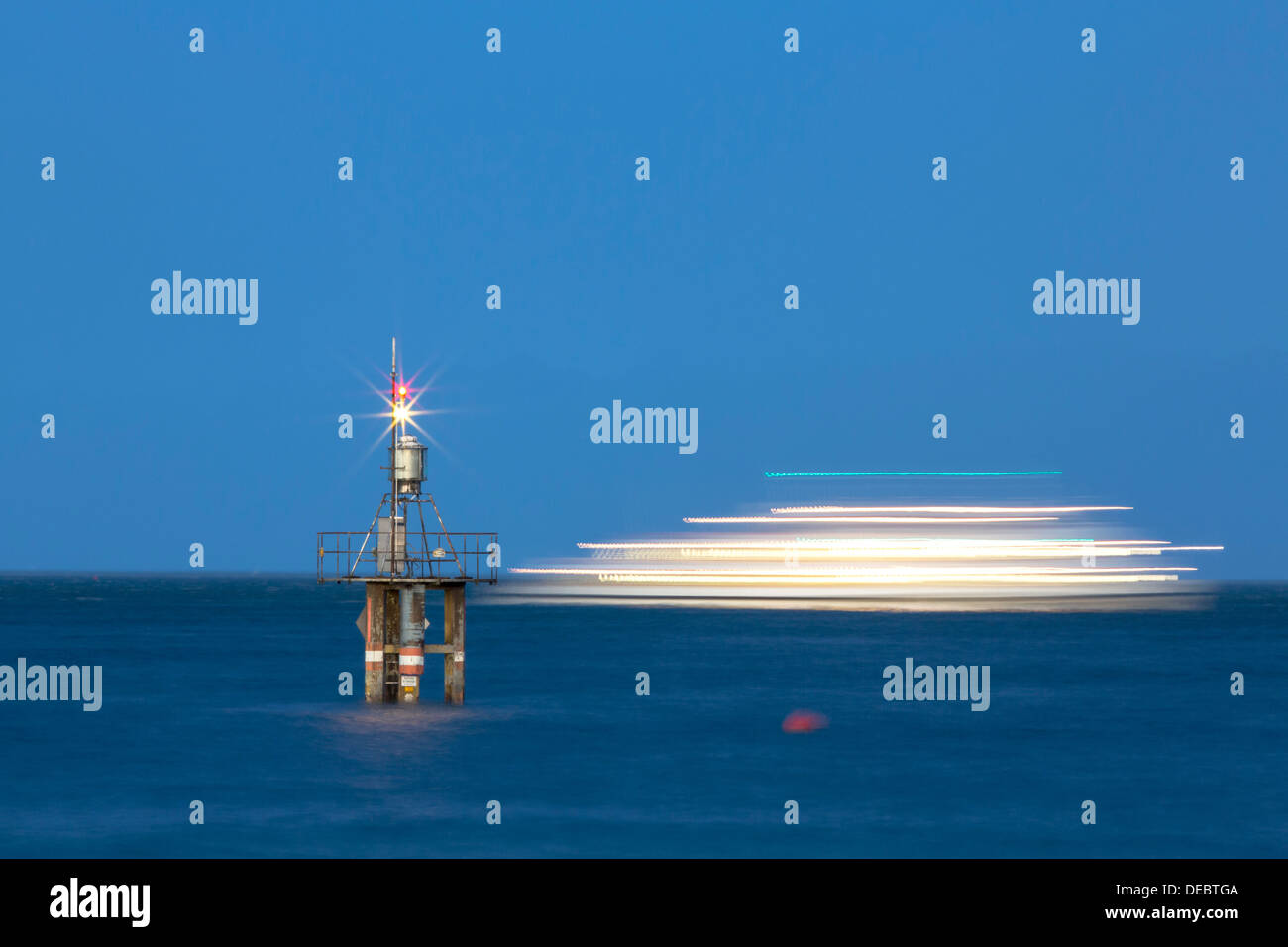 Evening mood with a with moving ship at the Hoernle Lighthouse, Lake Constance, Konstanz, Baden-Württemberg, Germany Stock Photo
