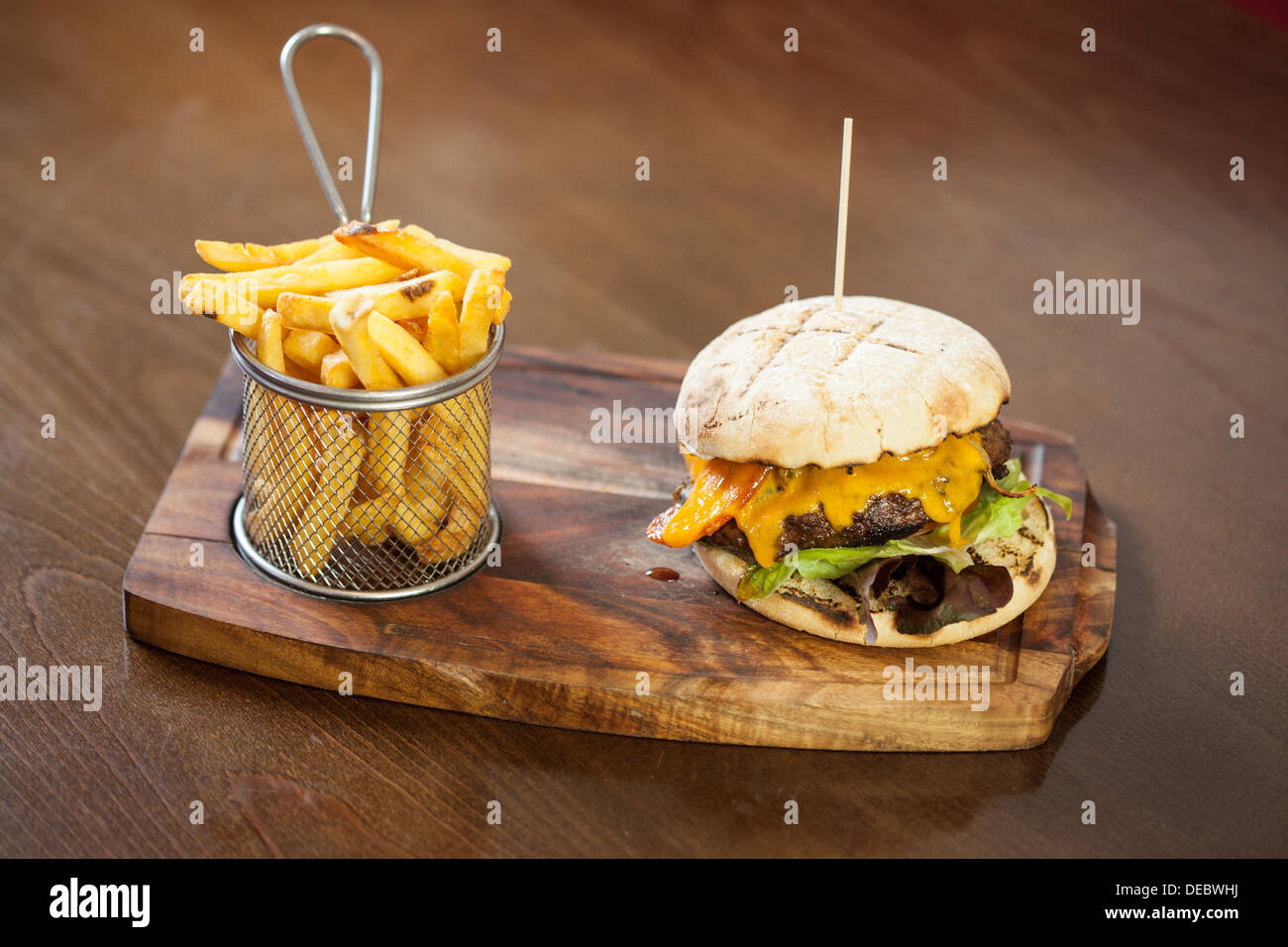 Close up on a cheese burger and french fries Stock Photo - Alamy