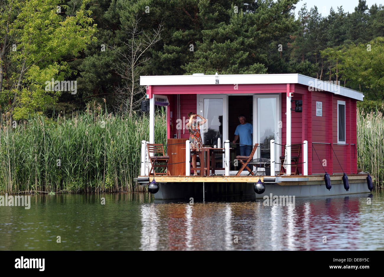 Brandenburg, Germany, tourist bungalow with a boat on the river Havel Stock Photo