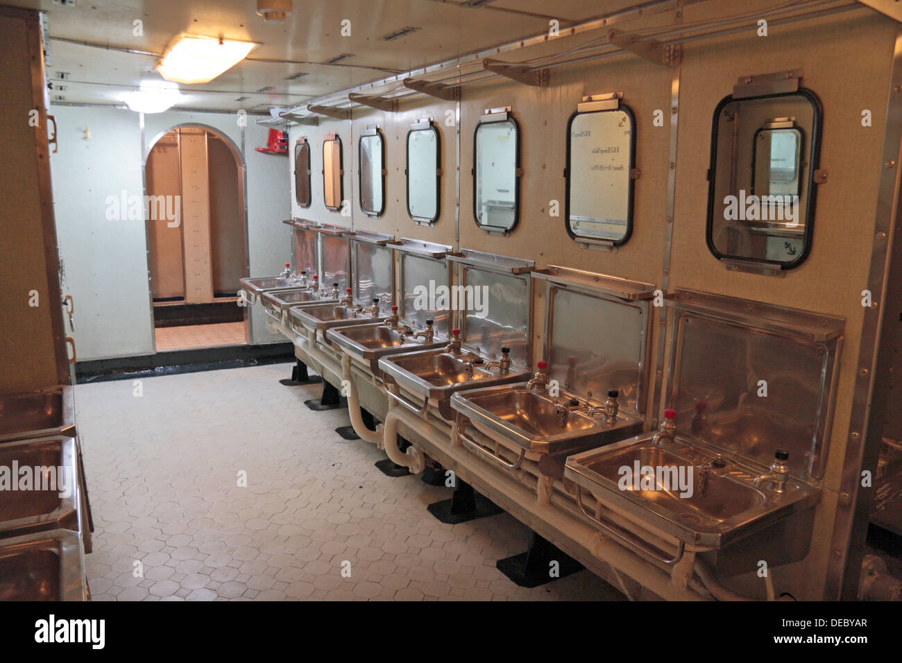 Crew's bathroom (after 1950's refit) on HMS Belfast, a Royal Navy light cruiser, moored on the River Thames, London, UK. Stock Photo