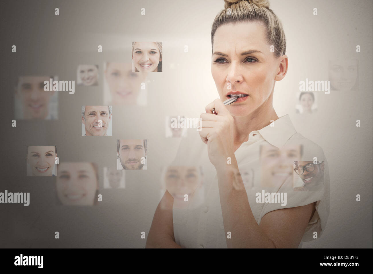 Stern businesswoman encircled by digital interface Stock Photo