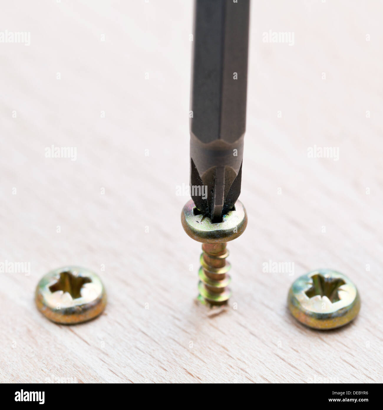 series wrapped screws in wooden plank Stock Photo Alamy