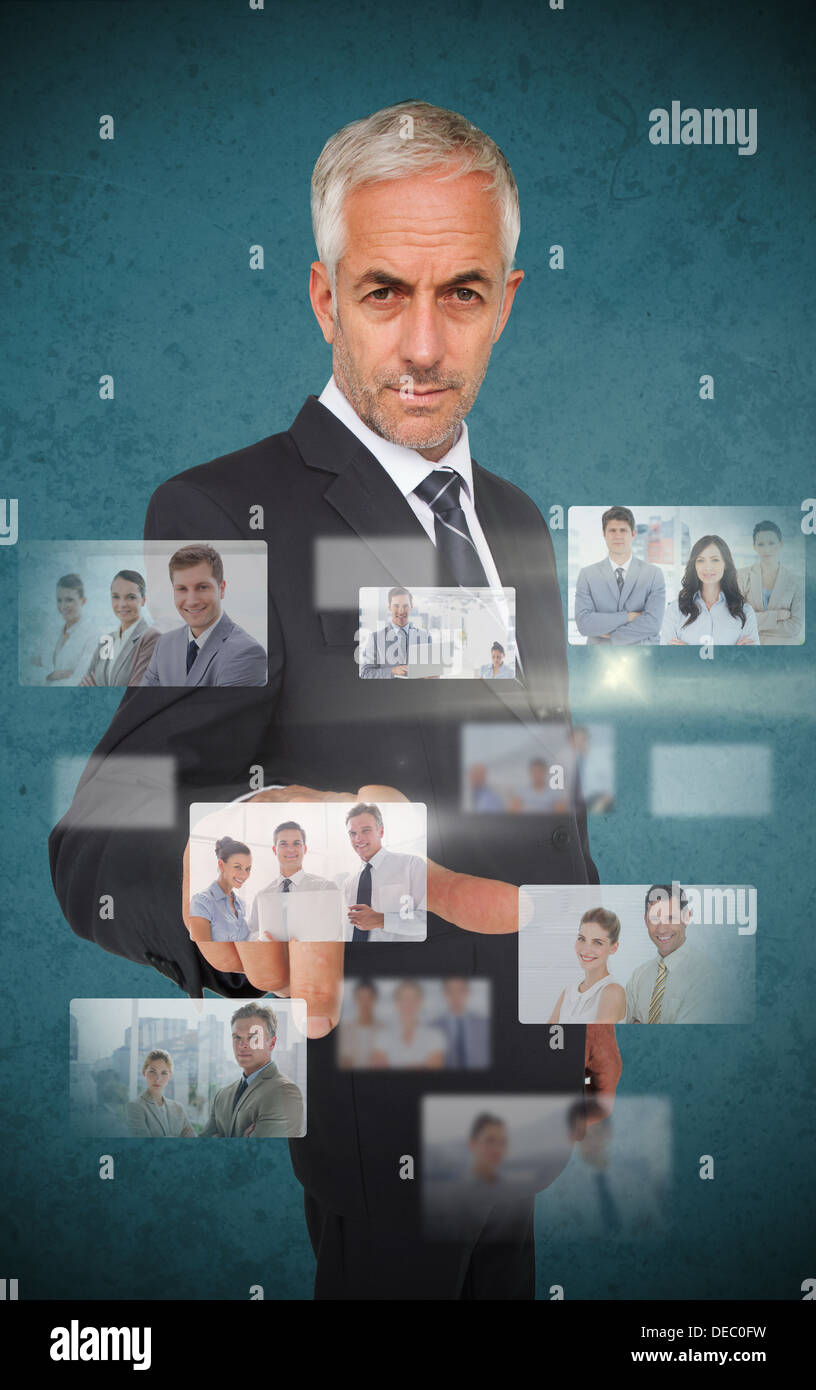 Mature stylish businessman using futuristic interface Stock Photo