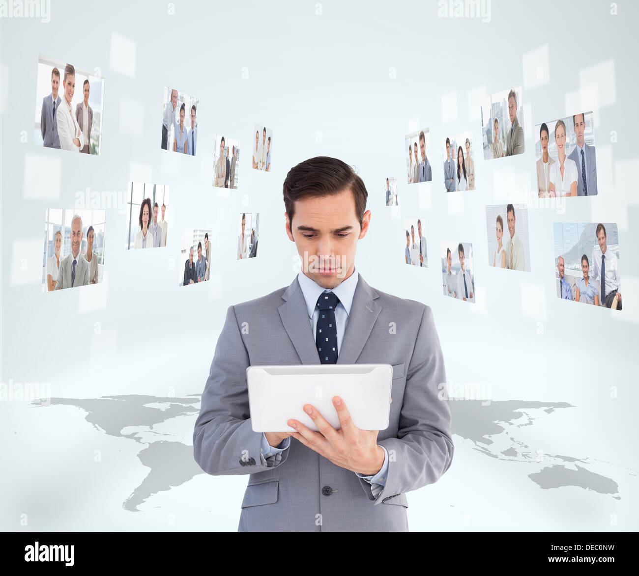 Businessman holding tablet encircled by digital interface Stock Photo