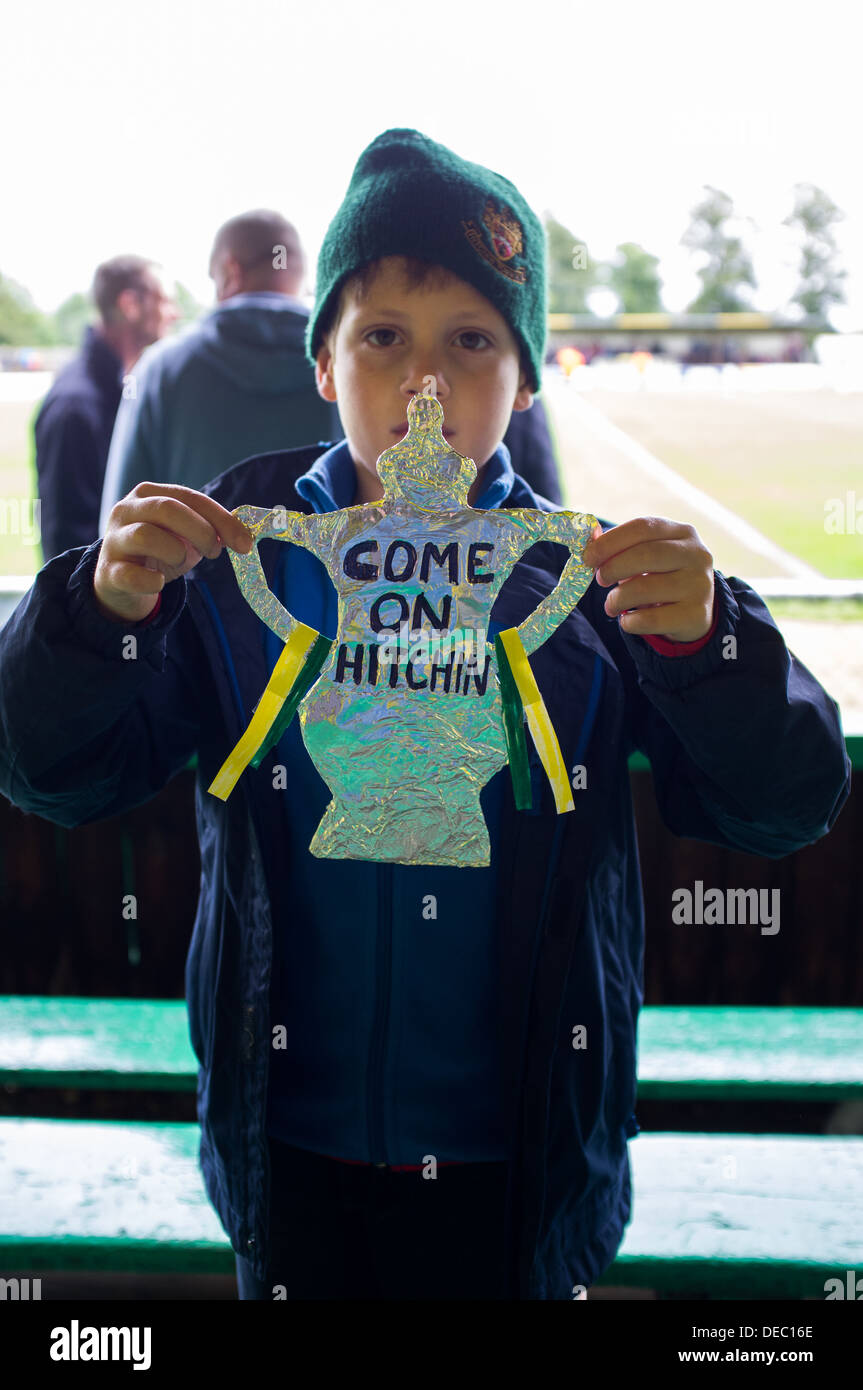 Young spectator supporting his local side at an FA Cup Match. Pictured holding a home made image of the FA Cup. Stock Photo
