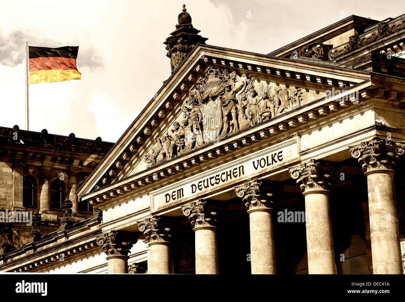German flag flying at the Reichstag Building of the German Federal Parliament, with the inscription 'Dem Deutschen Volke', Stock Photo