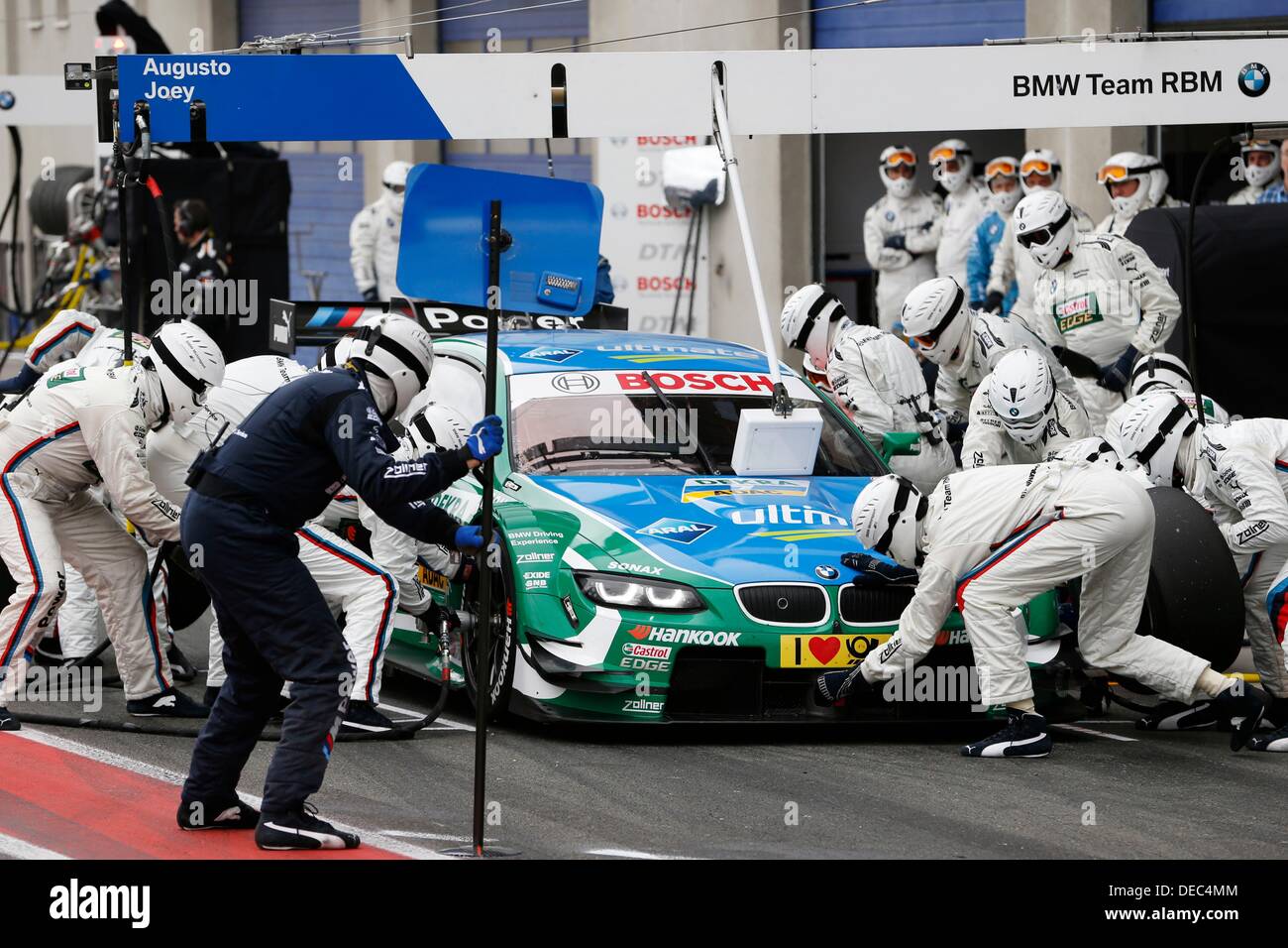 A handout photo released by Hoch Zwei on 15 September 2013 shows the Brazilian BMW-pilot Augusto Farfus during the pit stopp at the 8th race of the DTM in Oschersleben, Germany. Stock Photo