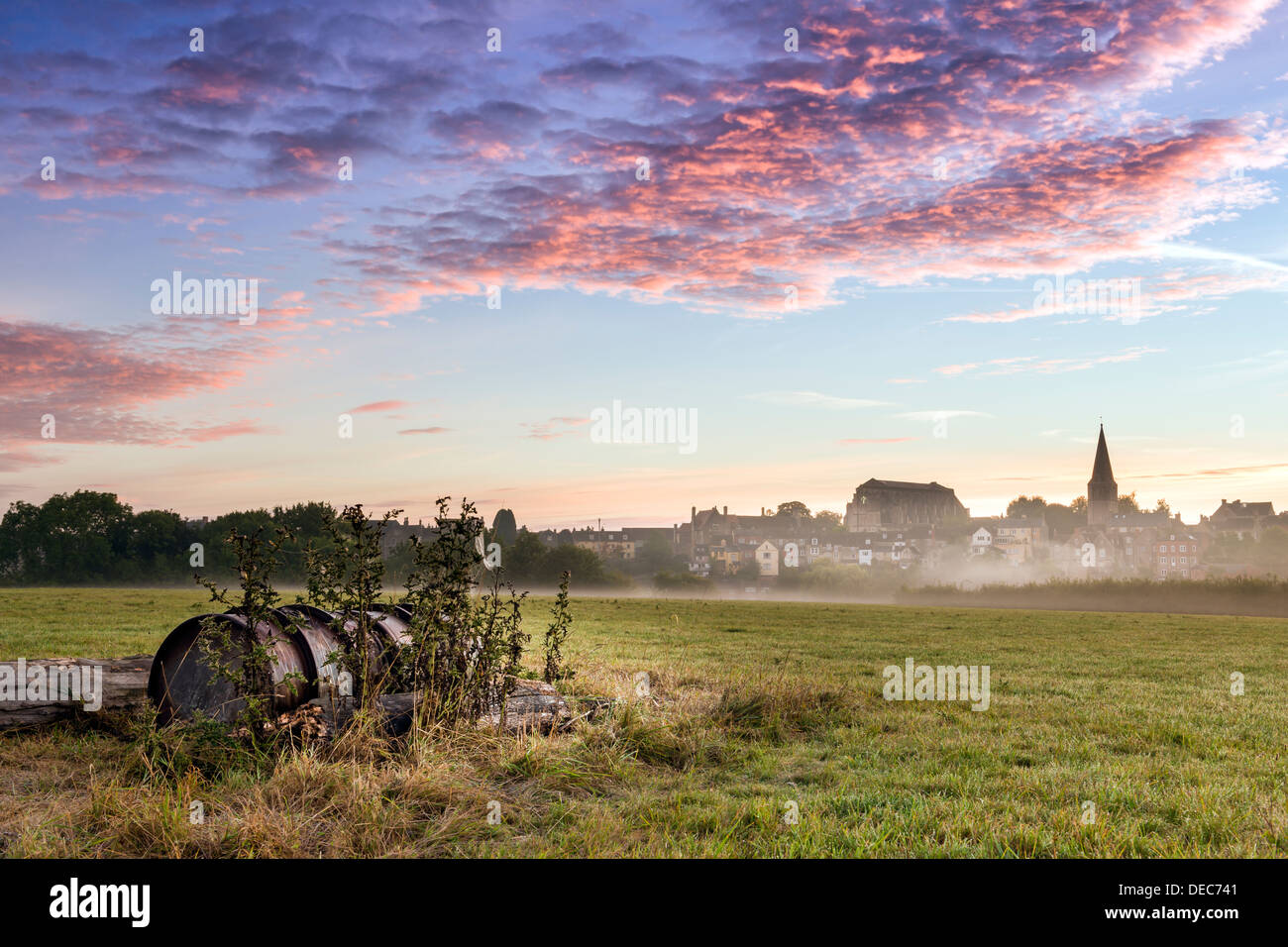 Malmesbury, Wiltshire. Church bells ring across the meadow on a misty ...