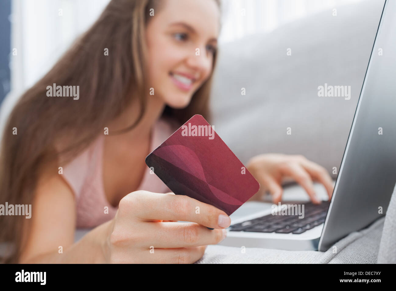Woman on the sofa doing online shopping Stock Photo