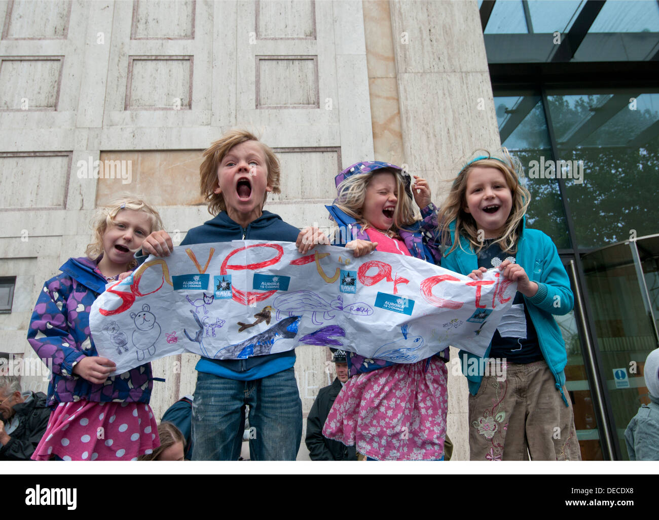 Children roar in front of Shell HQ to protest at oil drilling in the Arctic, organised by Greenpeace Stock Photo
