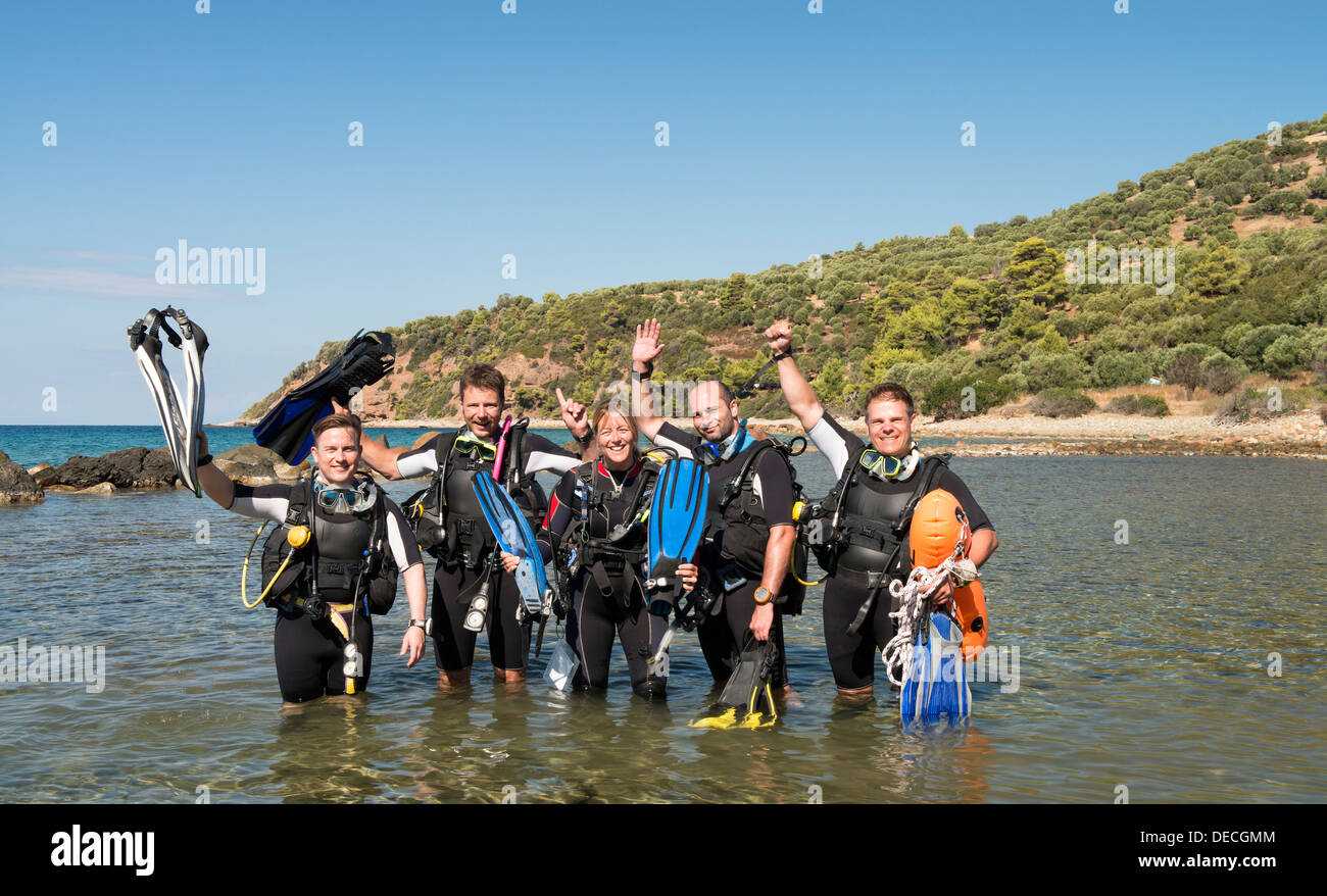 Group of young men and a female learning to dive Stock Photo