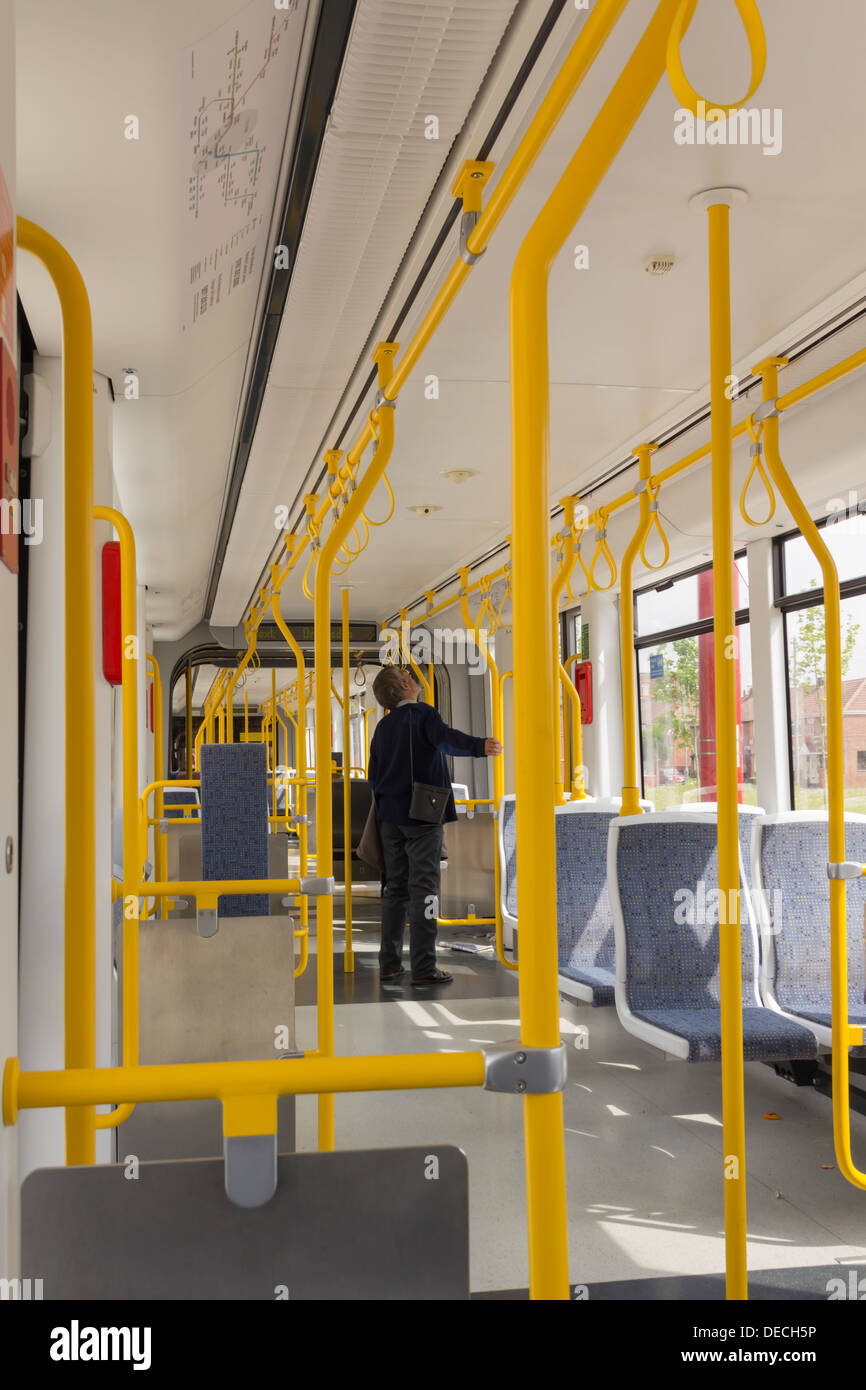 Manchester Metrolink tram interior with one adult male passenger waiting to disembark. Stock Photo