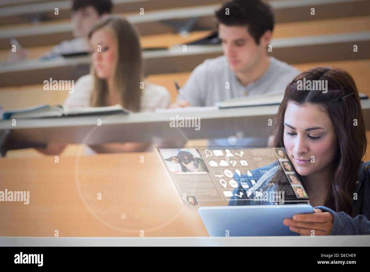 Focused pretty student working on her futuristic tablet Stock Photo