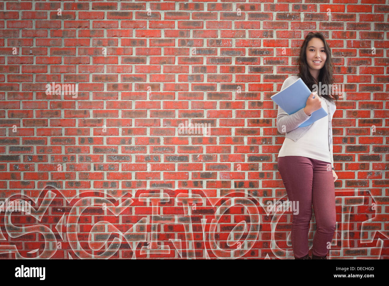 Smiling student holding notebook posing Stock Photo