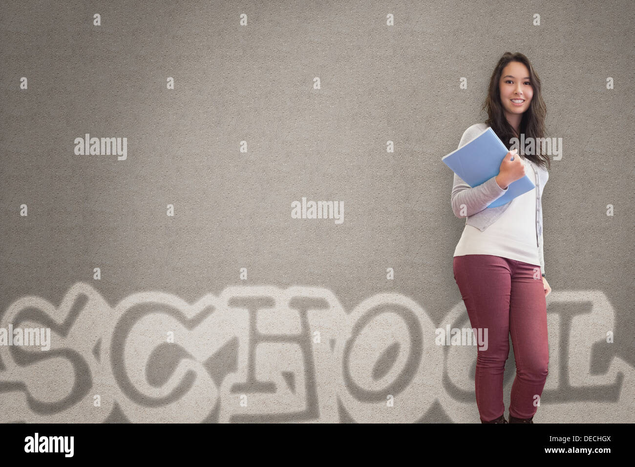 Cheerful student holding notebook posing Stock Photo