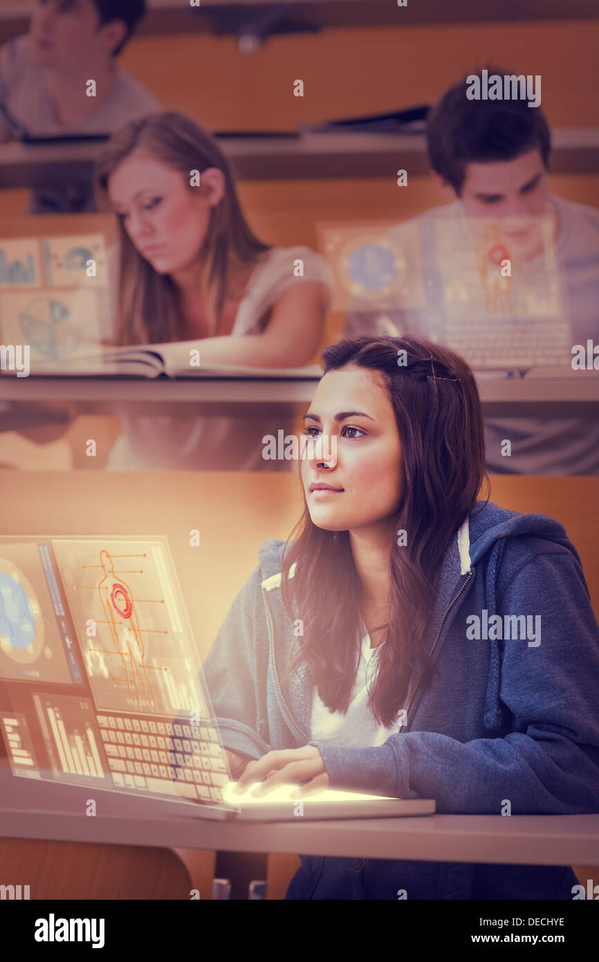 Concentrated pretty student working on her futuristic laptop Stock Photo