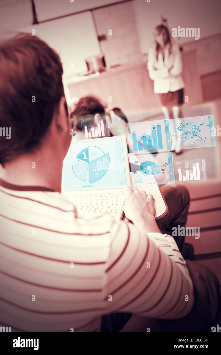 Focused student analysing graphs on his futuristic notebook Stock Photo
