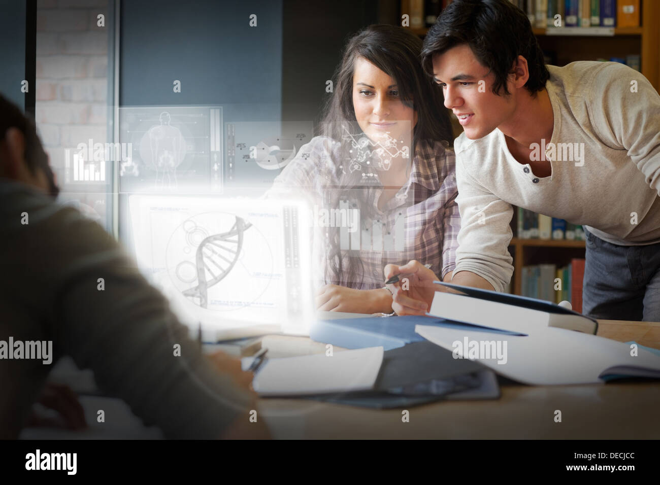 Concentrated students analysing dna on digital interface Stock Photo