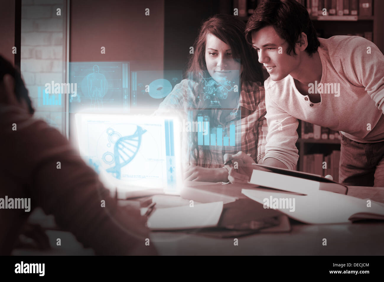 Focused students analysing dna on digital interface Stock Photo