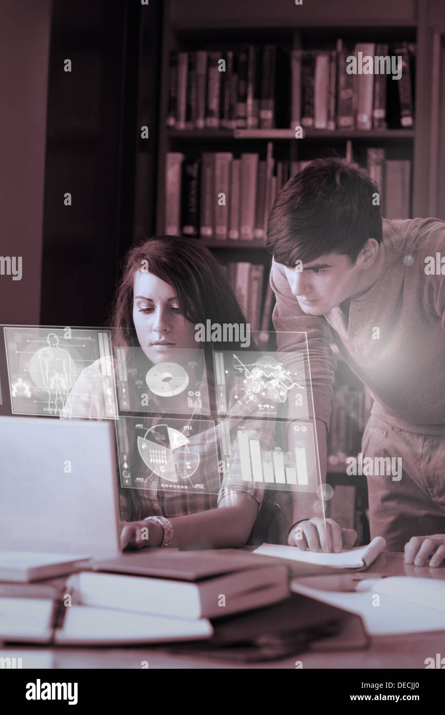 Focused students analysing graphs on their digital interface Stock Photo