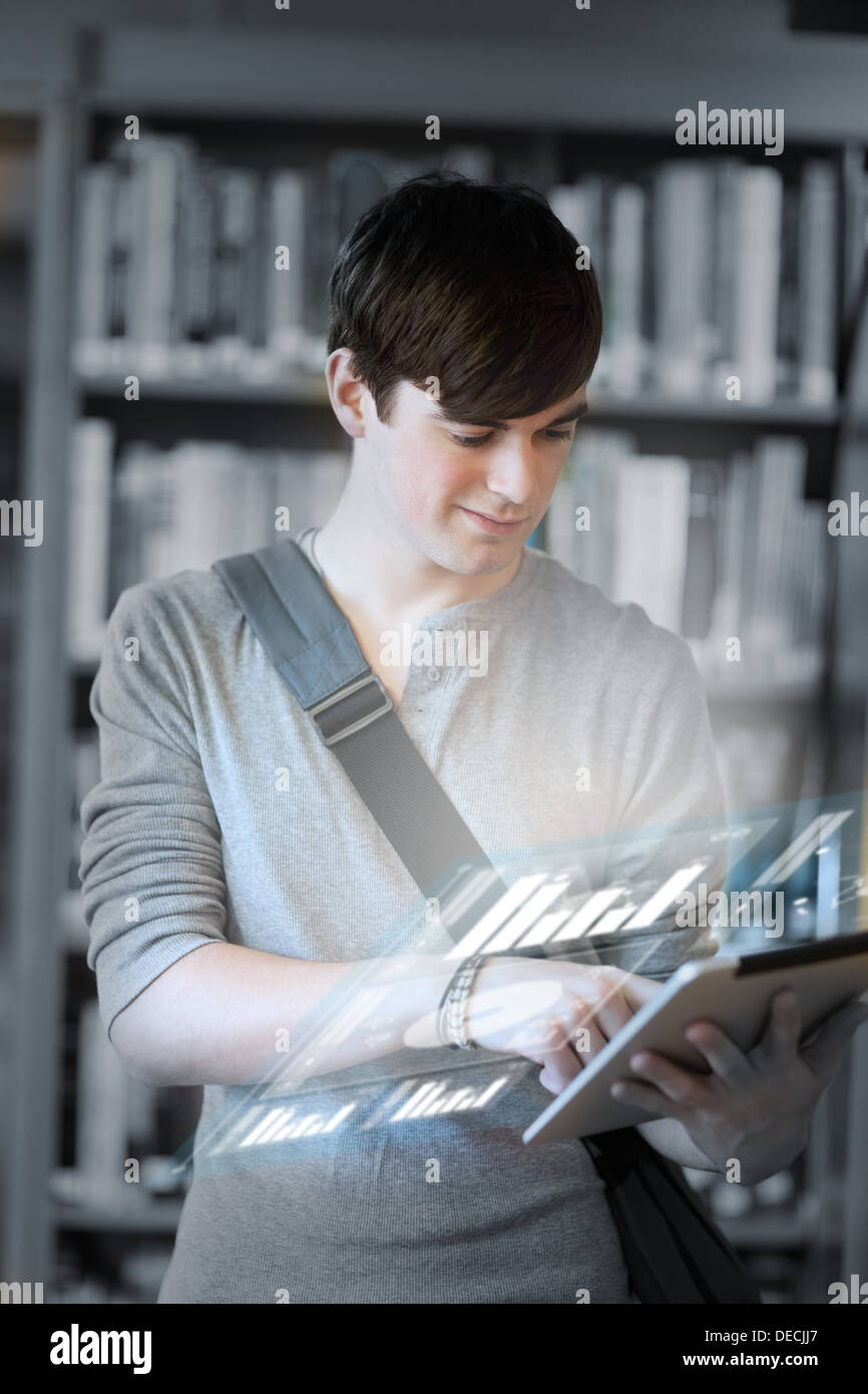Focused student analysing graphs on his digital tablet Stock Photo