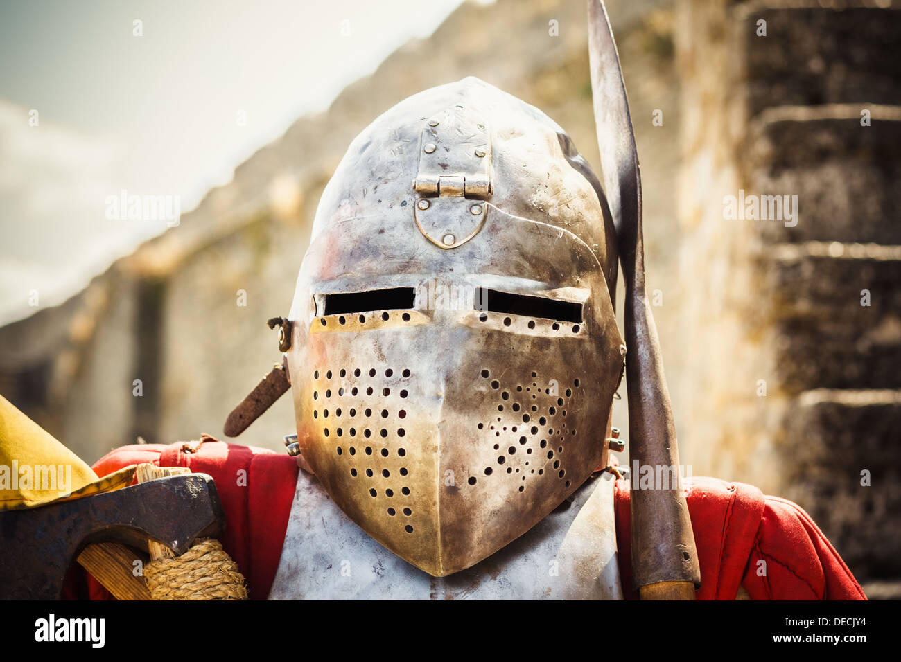 Medieval knight in helmet on ancient wall background Stock Photo