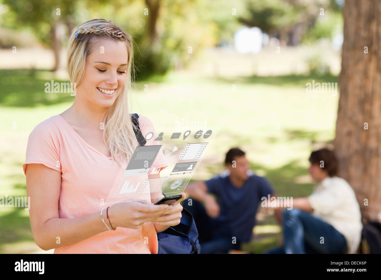 Pretty blonde working on her digital smartphone Stock Photo