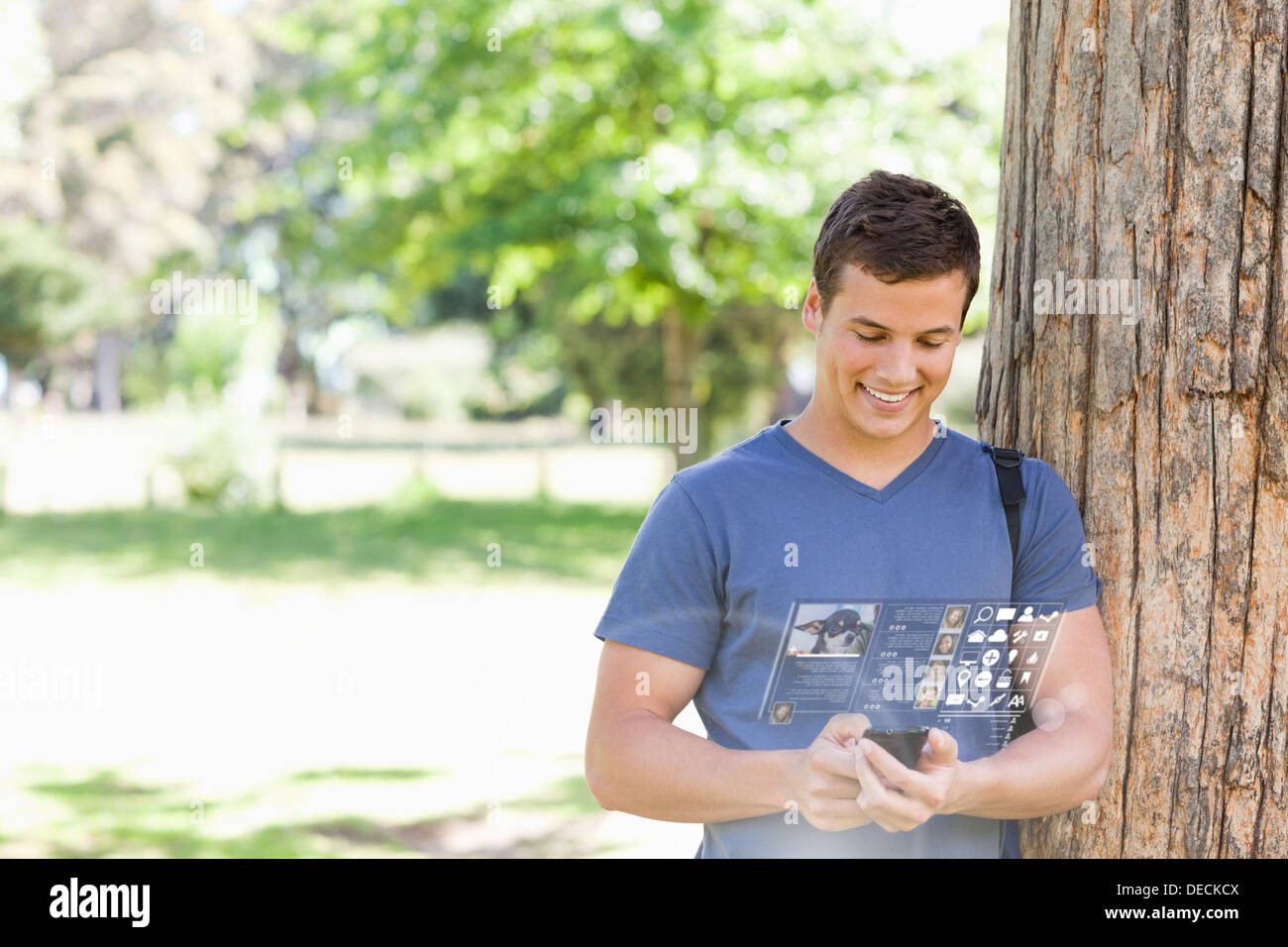 Cheerful handsome student using his digital smartphone Stock Photo