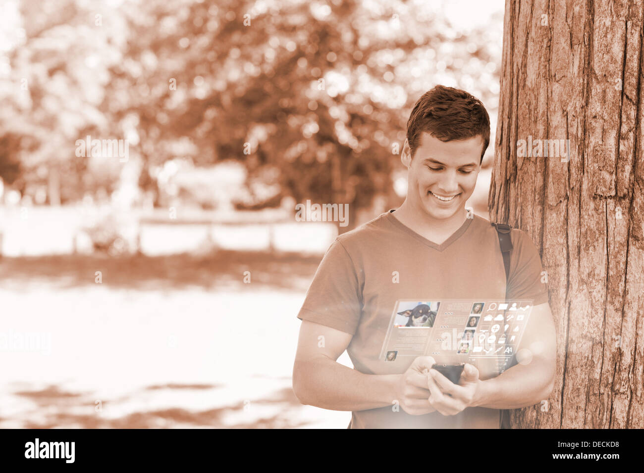 Cheerful handsome student using his digital phone Stock Photo