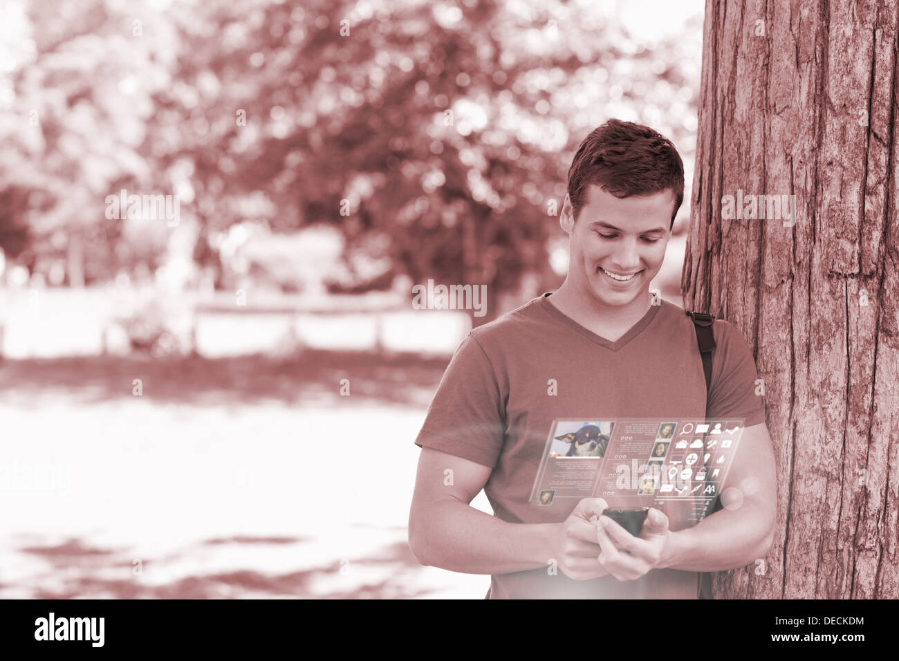 Smiling handsome student using his digital phone Stock Photo