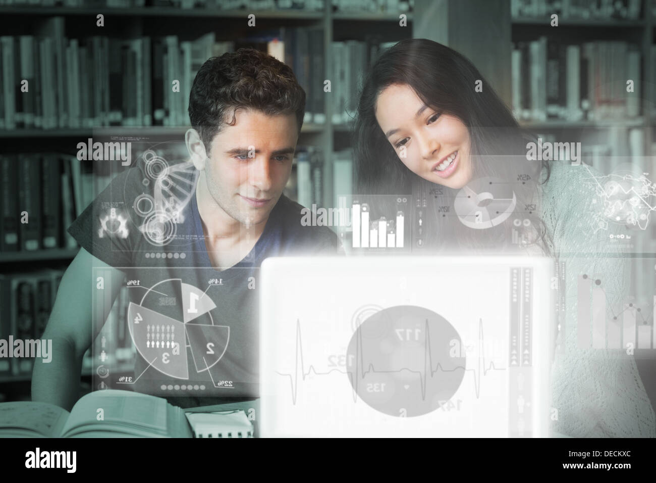 Cheerful college friends studying on digital interface Stock Photo