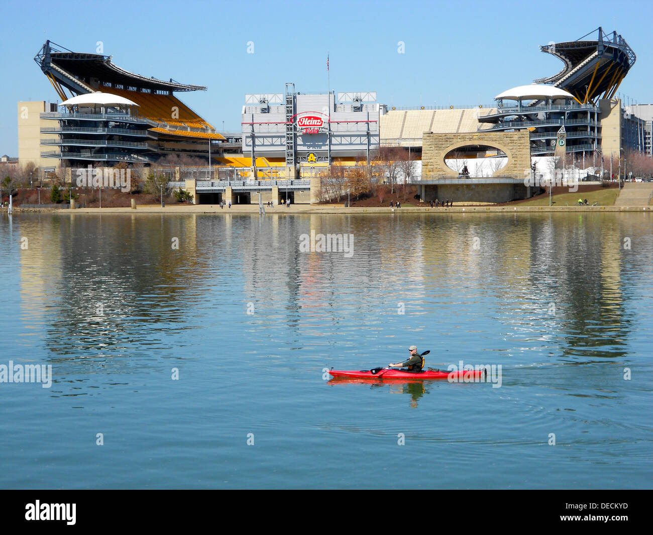 Canoer on the Allegheny River in Pittsburgh near the confluence with the Monongahela River at the Forks of the Ohio (Point State Park). Heinz Stadium (Home of the Steelers) in the background. Stock Photo