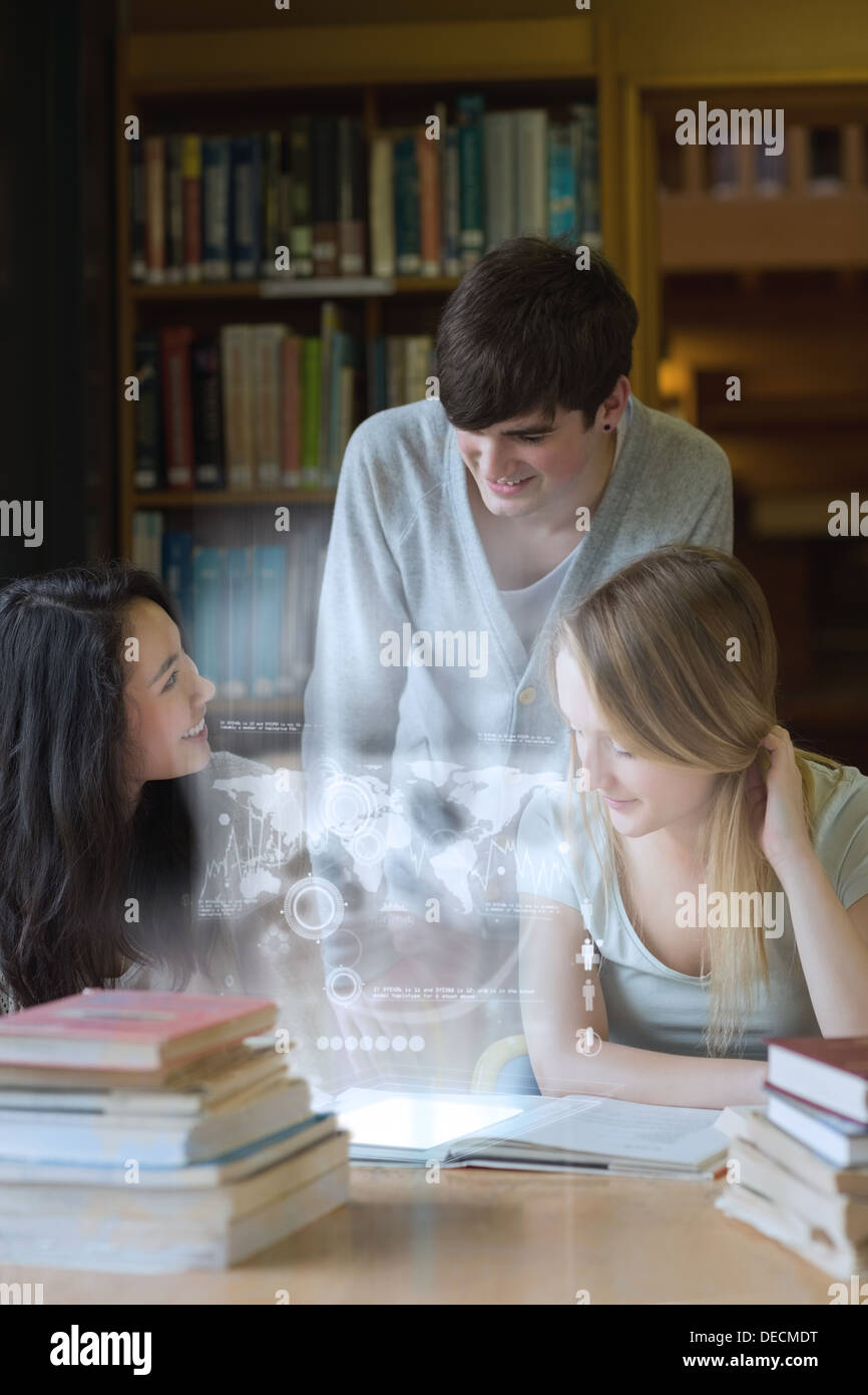 Happy students working together with futuristic interface Stock Photo
