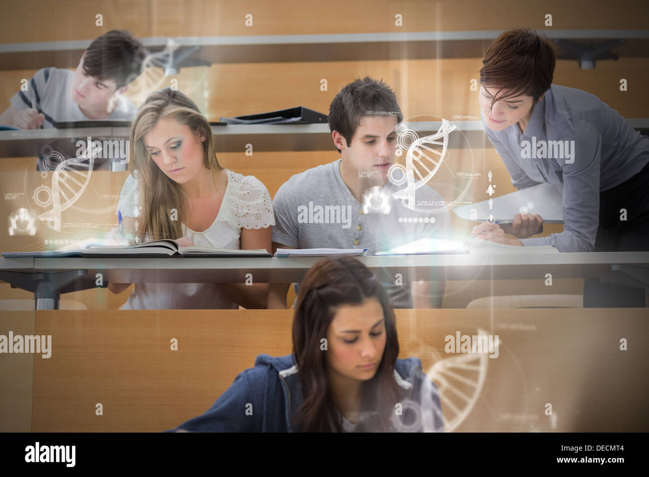 Students using futuristic interface to learn about science from tablet pcs Stock Photo