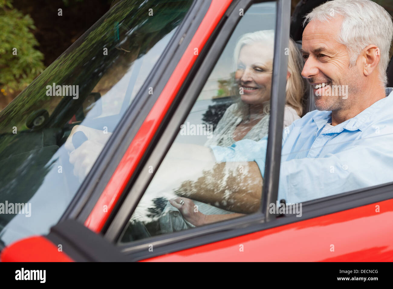 Happy mature man having a ride with his wife Stock Photo - Alamy