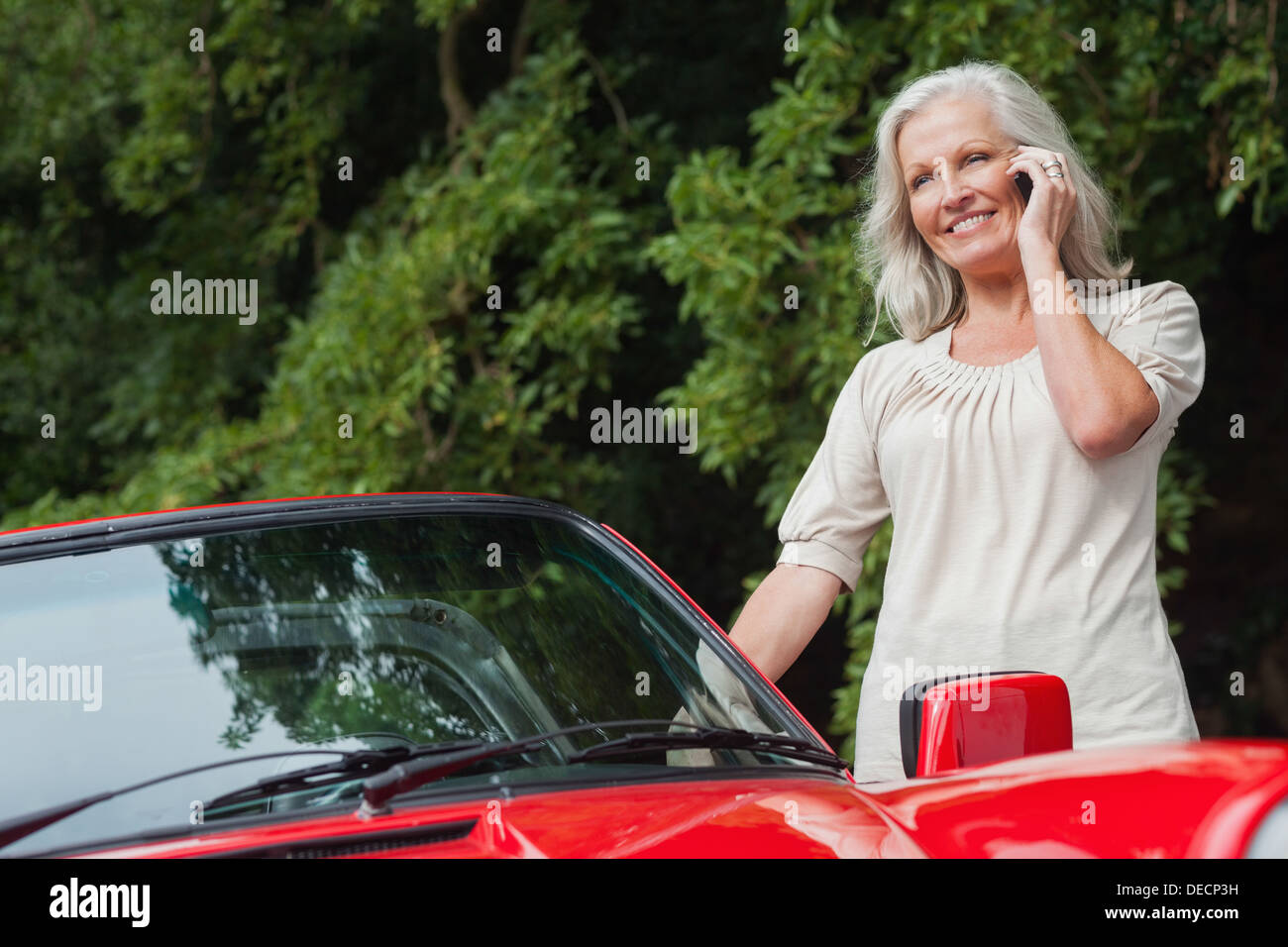 Smiling mature woman having phone call Stock Photo