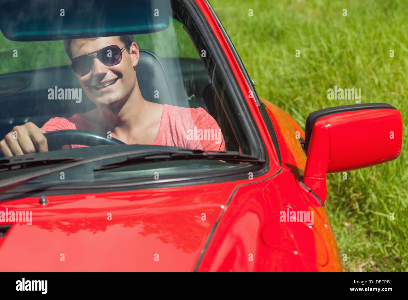 Smiling handsome man driving his cabriolet Stock Photo