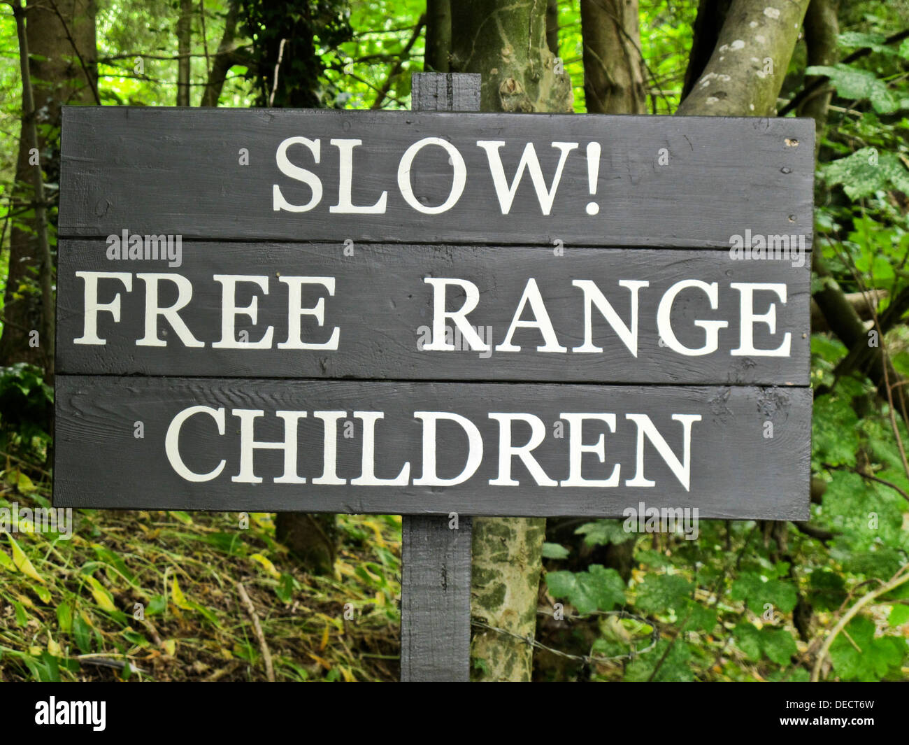 'Slow! Free Range Children' road safety sign in Castle Combe. Wiltshire, UK Stock Photo