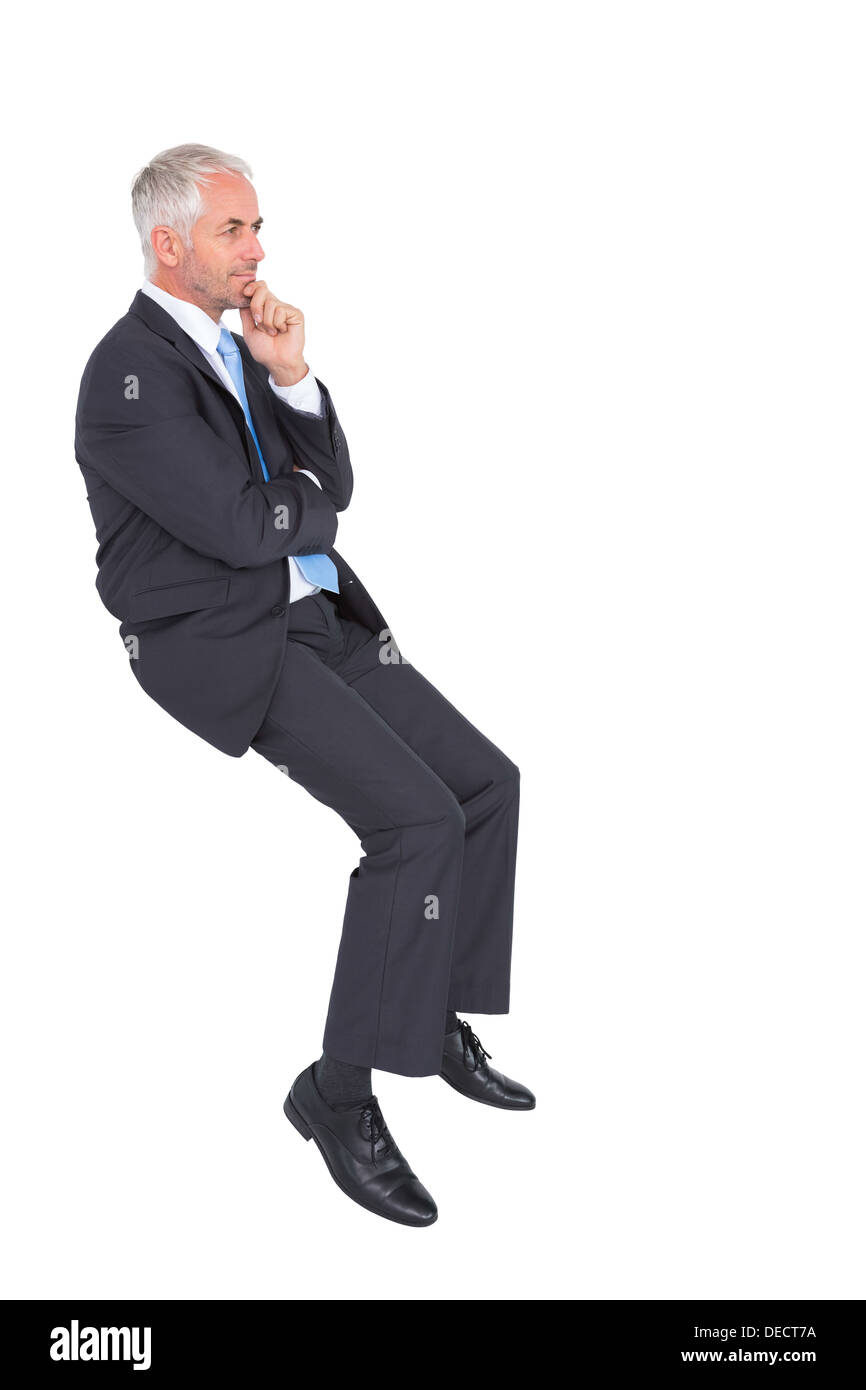 Businessman looking up while thinking Stock Photo