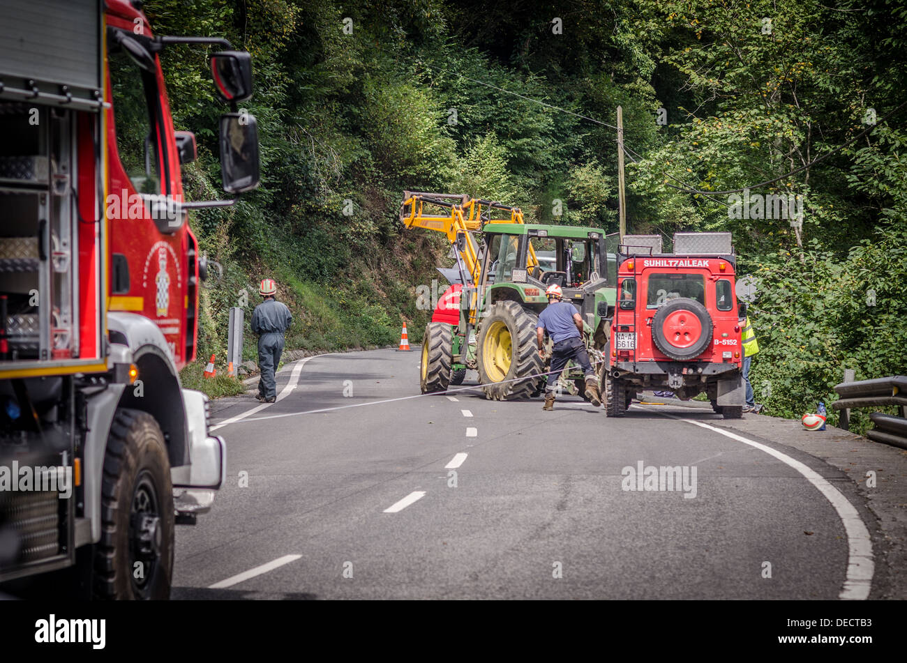 Fire service and farmer's tractor retrieve car that went over cliff edge Stock Photo