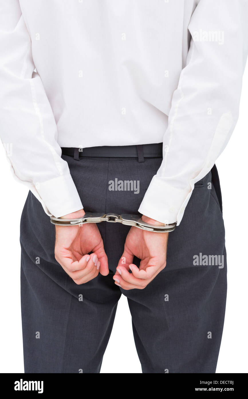 Close up on young businessman wearing handcuffs Stock Photo