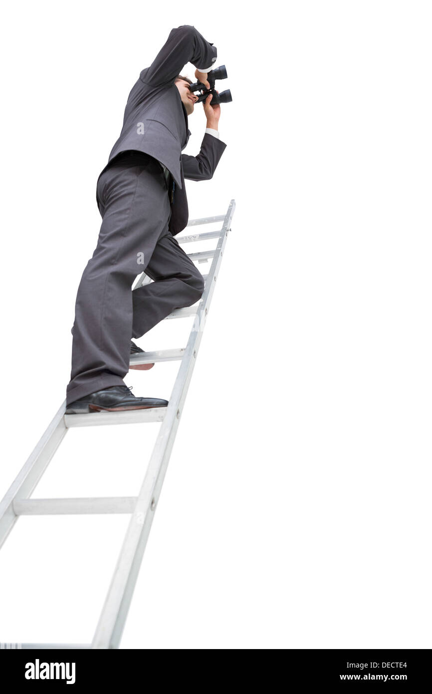 Low angle view of businessman standing on ladder using binoculars Stock Photo