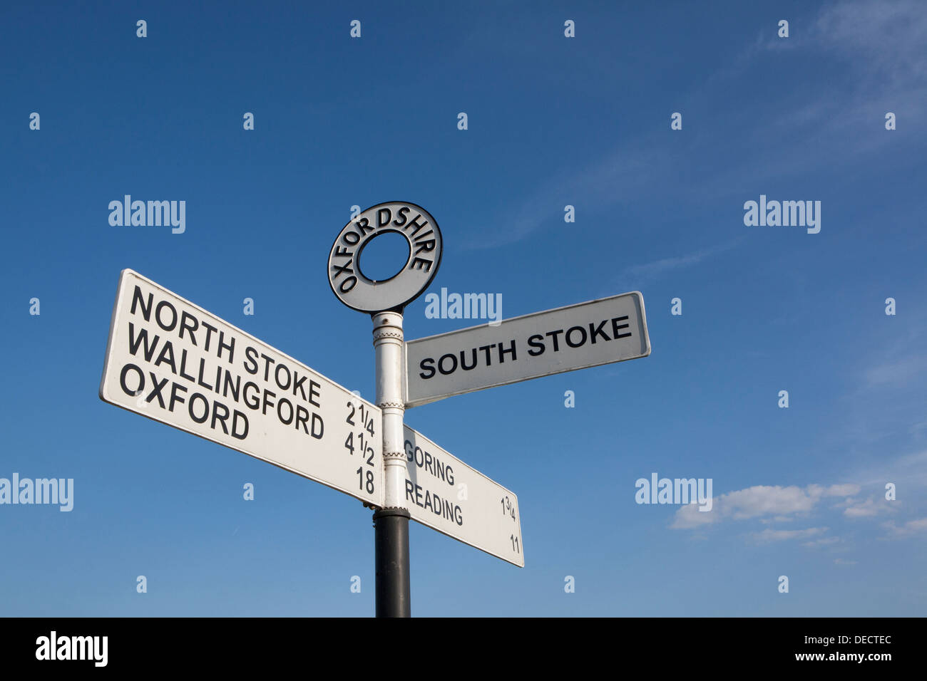 An old Oxfordshire cast iron road sign against a blue sky. Stock Photo