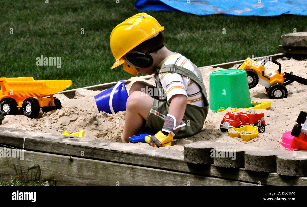 Boy plaing in sand Stock Photo